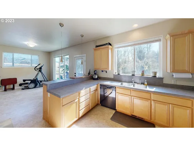 a kitchen with sink a stove and cabinets