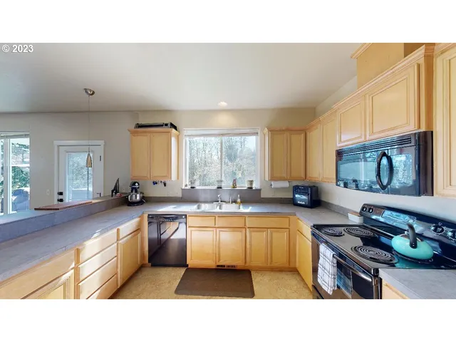 a kitchen with stainless steel appliances granite countertop a refrigerator a sink dishwasher a stove with wooden cabinets