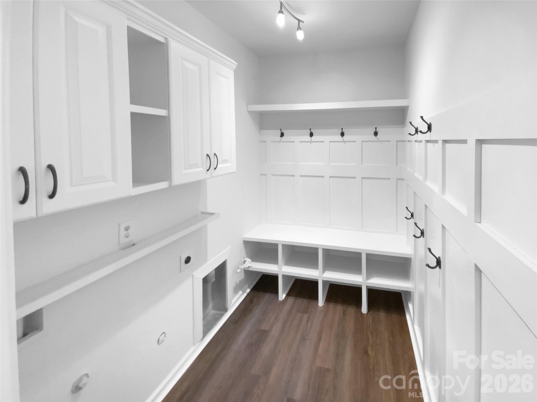 9676 Ravenscroft Lane Northwest Concord, NC 28027 - Photo 13 of 23 a view of a hardwood room with stairs and racks