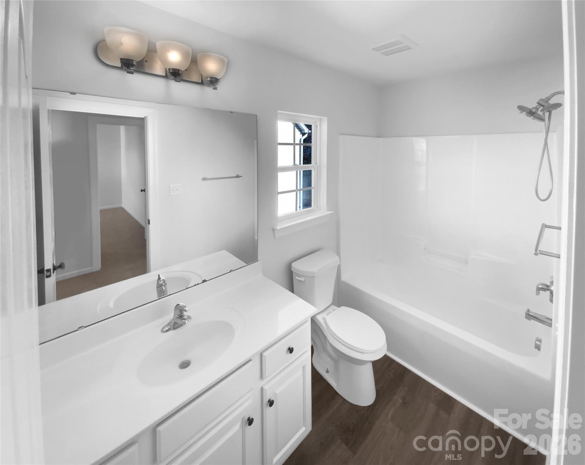 9676 Ravenscroft Lane Northwest Concord, NC 28027 - Photo 15 of 23 a bathroom with a sink a toilet a mirror and shower