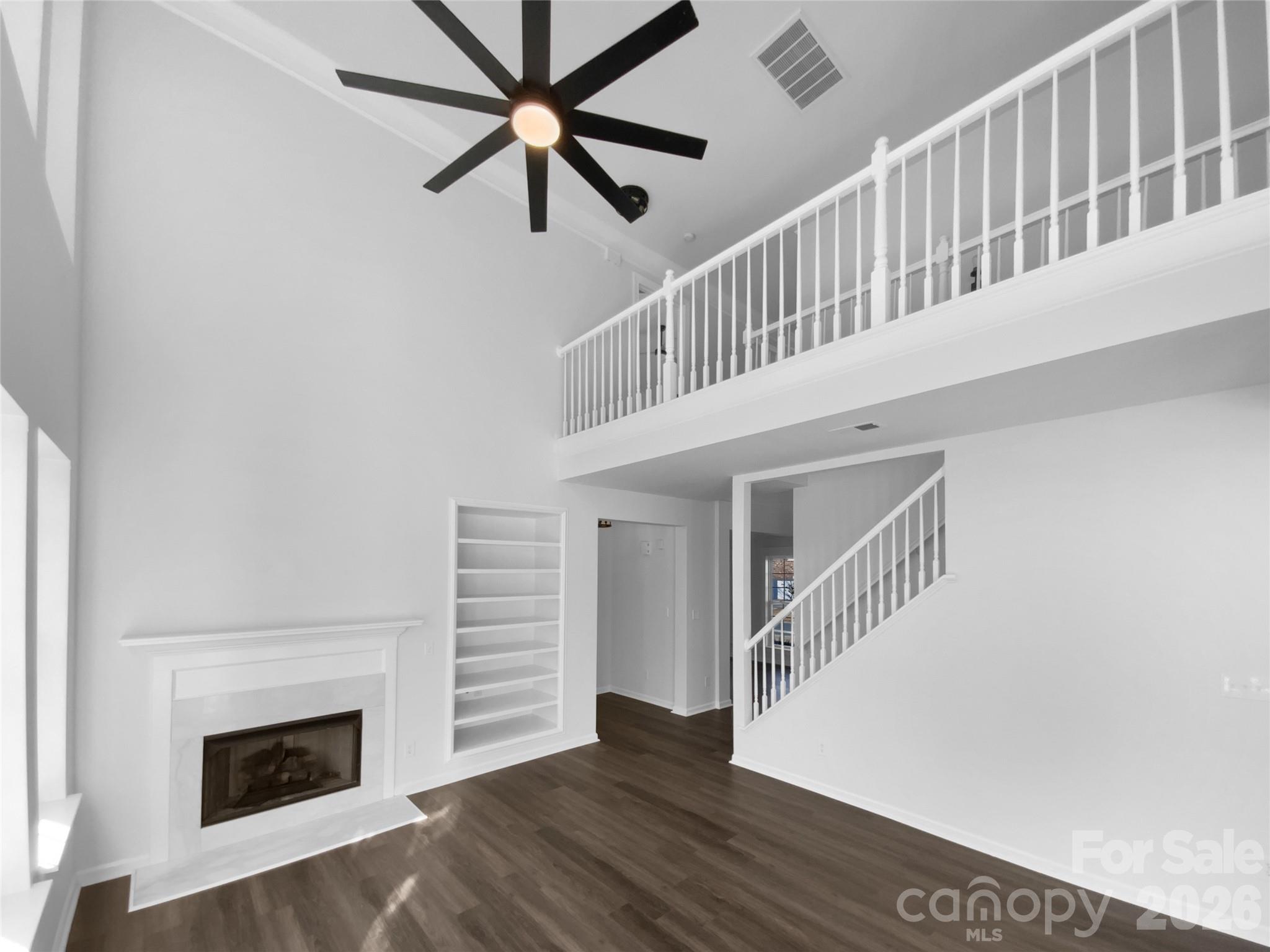9676 Ravenscroft Lane Northwest Concord, NC 28027 - Photo 3 of 23 a view of staircase with white walls and a fireplace