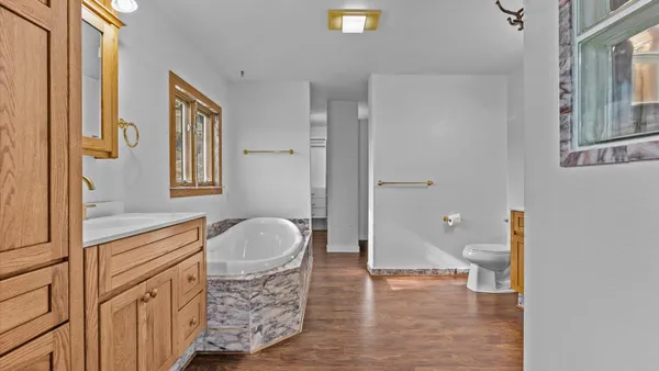 a bathroom with a shower a sink and a mirror