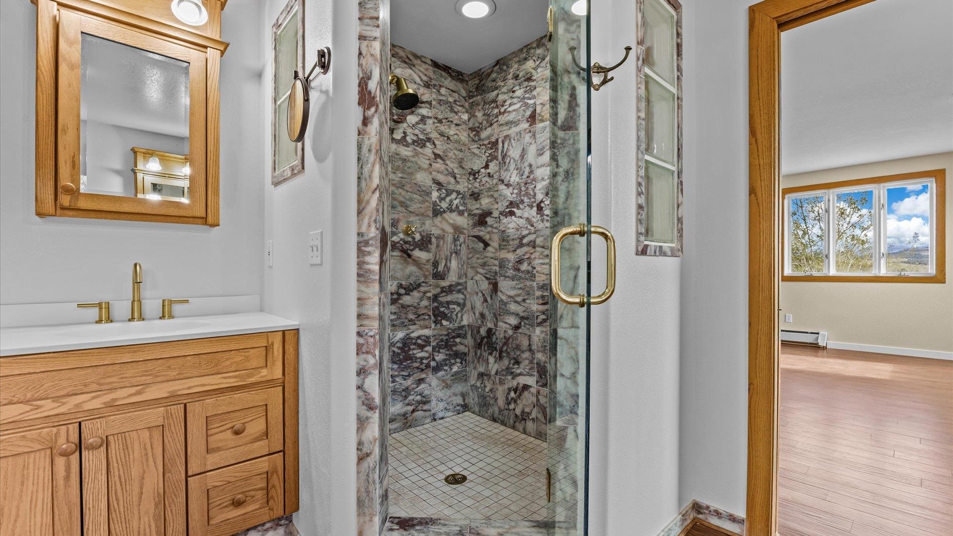 2737 Six Lazy K Road Silt, CO 81652 - Photo 24 of 42 a bathroom with a shower a sink and a mirror