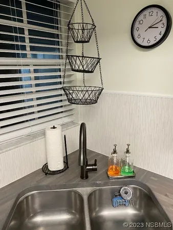 a kitchen with a sink and a mirror