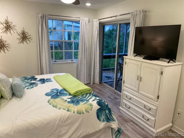a bedroom with a bed and a flat screen tv