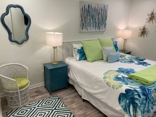 a bedroom with a bed and a painting on the wall