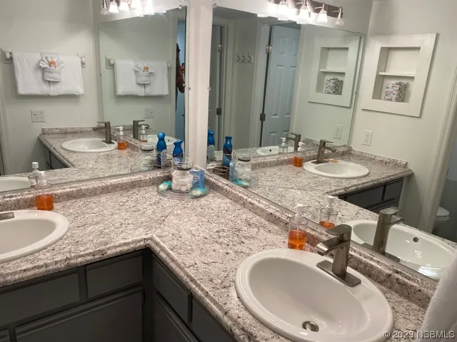 a bathroom with a sink double vanity and a mirror