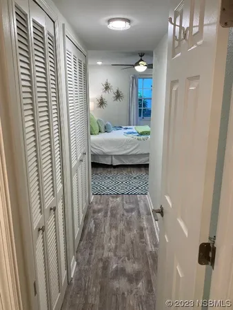 a view of a hallway and a livingroom with furniture
