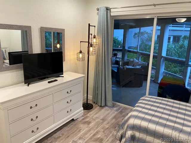 a bedroom with a bed and a flat tv screen in it