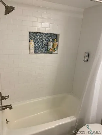 a bathroom with a bathtub and toilet