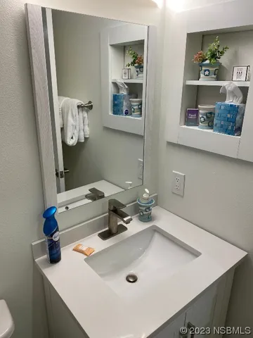 a bathroom with a sink a toilet and a mirror
