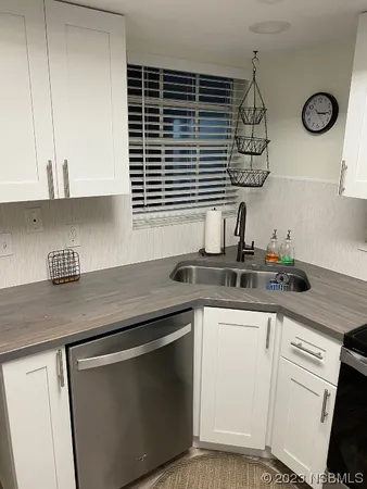 a kitchen with stainless steel appliances granite countertop a sink and a stove