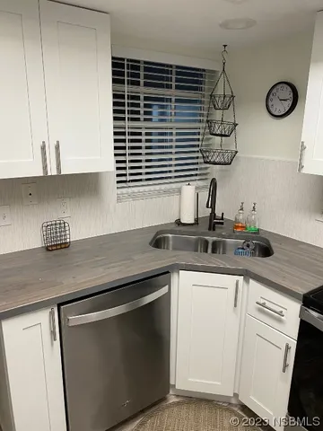 a kitchen with stainless steel appliances granite countertop a sink and a stove