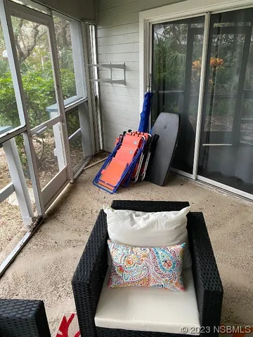 a view of living room with furniture and a floor to ceiling window