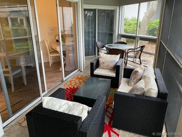 a balcony with furniture and a potted plant