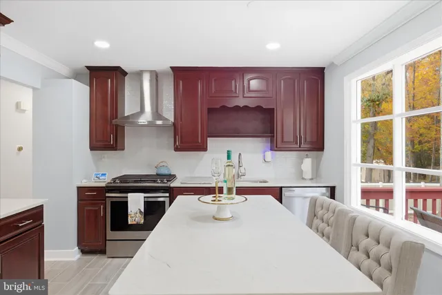 a kitchen with stainless steel appliances granite countertop a sink stove and cabinets