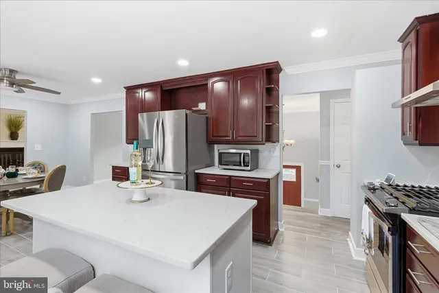 a kitchen with stainless steel appliances a stove refrigerator sink and microwave