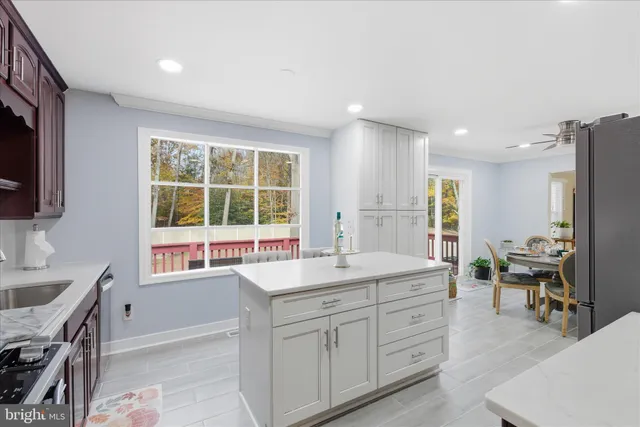 a kitchen with sink stove and refrigerator
