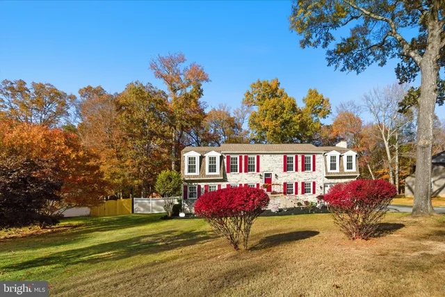 a front view of house with yard and trees around