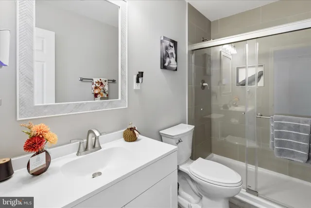 a bathroom with a sink toilet and shower