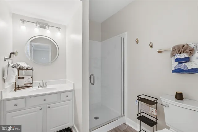 a bathroom with a granite countertop sink toilet and a mirror
