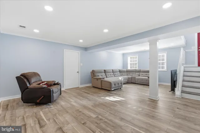 a living room with furniture and a wooden floor