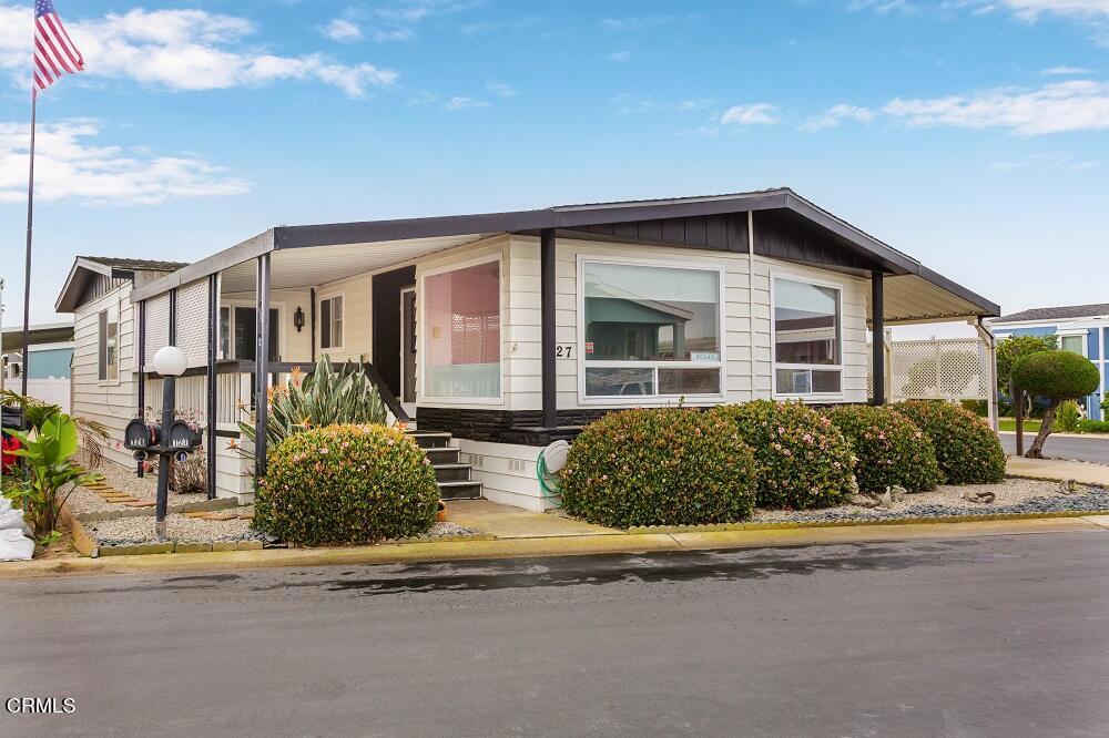 a front view of a house with a garden