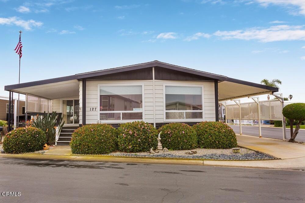 5540 West 5th Street, Unit 127 Oxnard, CA 93035 - Photo 2 of 17 a front view of a house with a yard