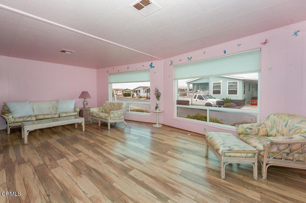 5540 West 5th Street, Unit 127 Oxnard, CA 93035 - Photo 5 of 17 a living room with furniture and wooden floor
