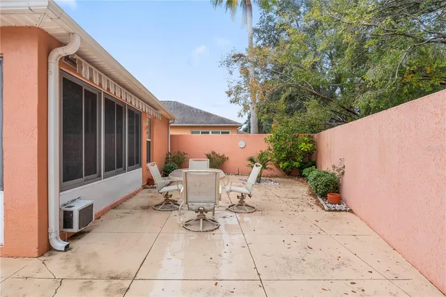 a view of a patio with table and chairs and potted plants