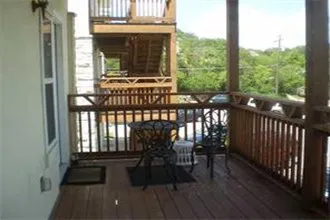 a view of balcony with furniture and wooden floor