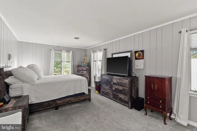 a bed room with furniture and a flat screen tv