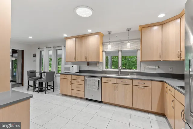 a large kitchen with white cabinets