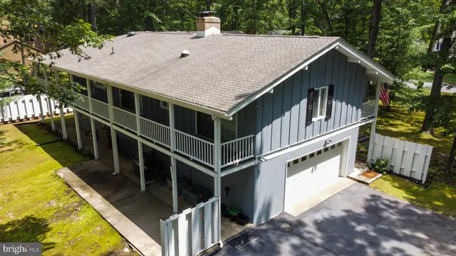 a view of a house with pool and wooden fence