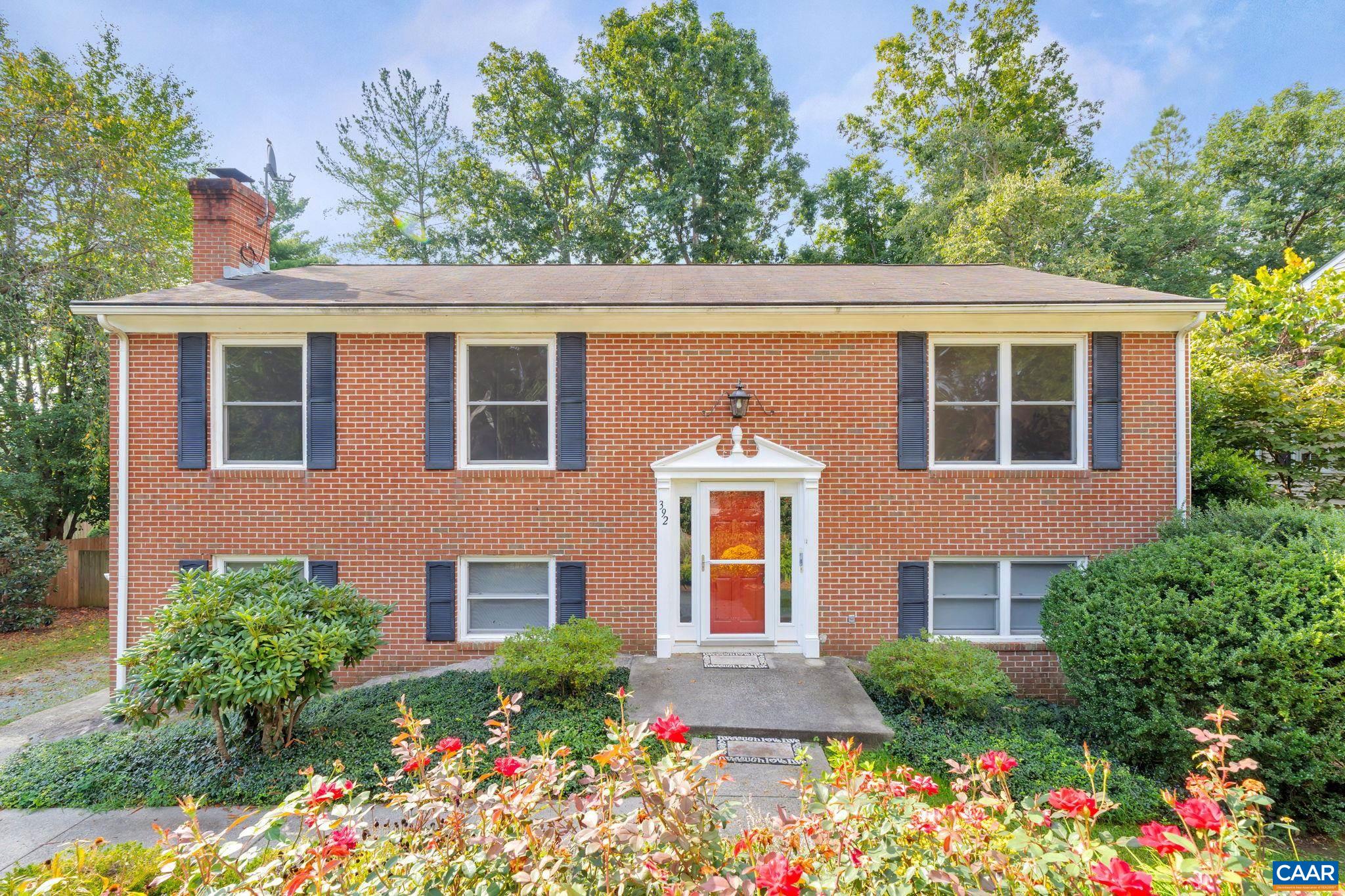 a front view of a house with a yard and outdoor seating