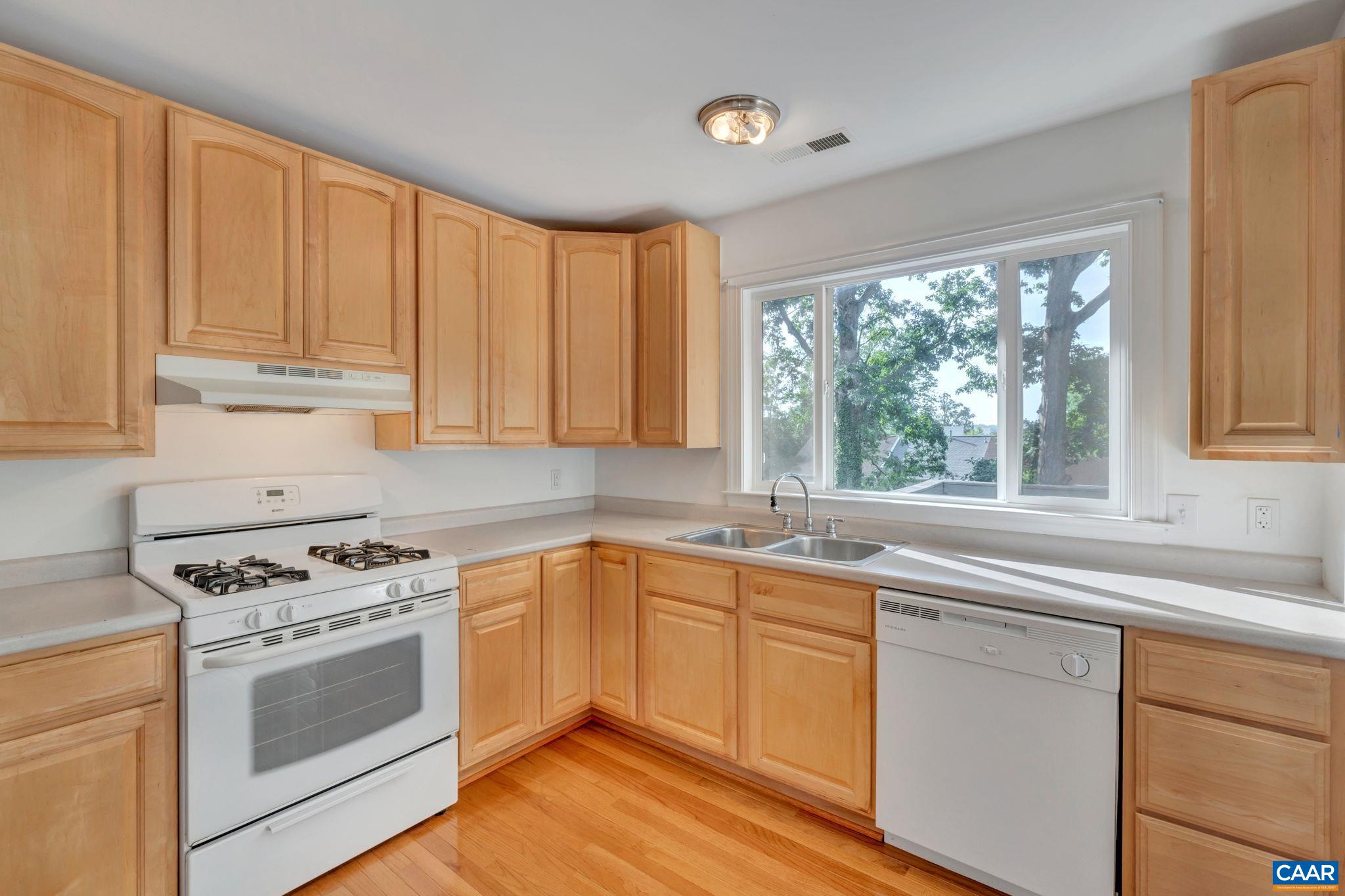 392 Minor Ridge Road Charlottesville, VA 22901 - Photo 17 of 47 a kitchen with granite countertop white cabinets and white appliances