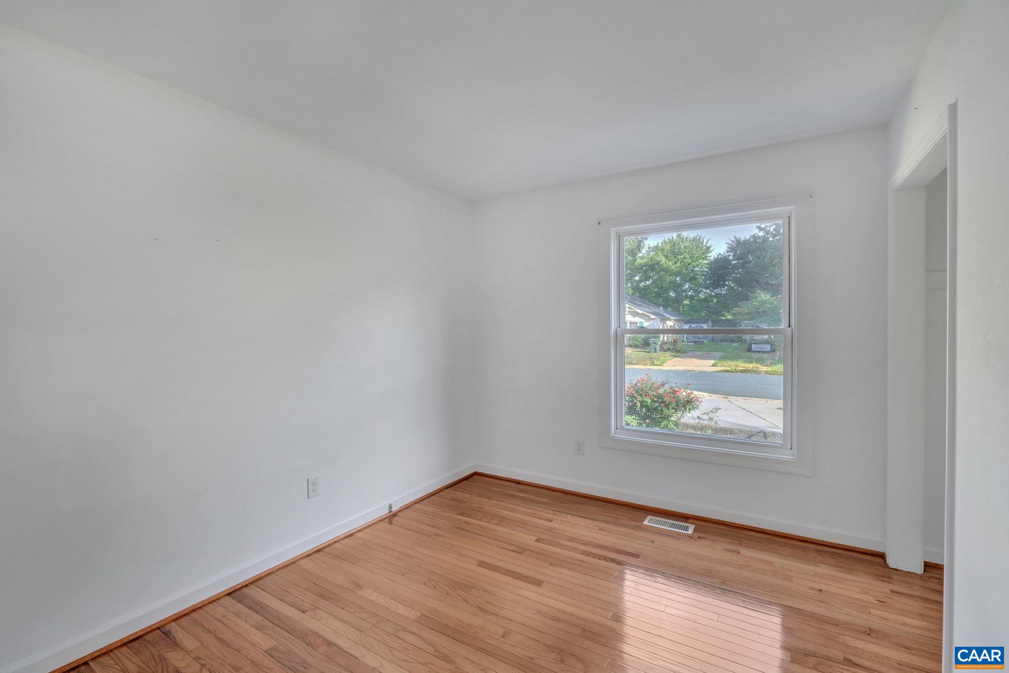 392 Minor Ridge Road Charlottesville, VA 22901 - Photo 19 of 47 an empty room with wooden floor and windows