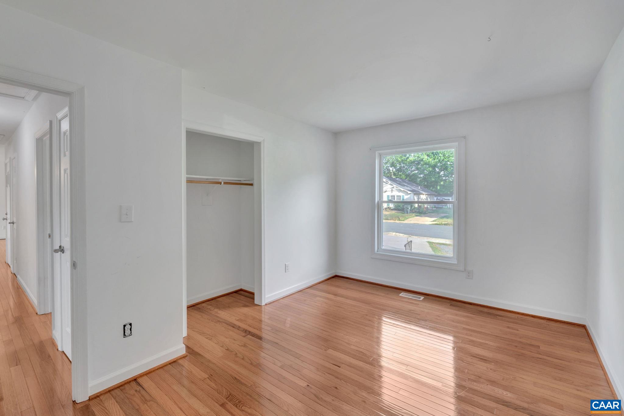392 Minor Ridge Road Charlottesville, VA 22901 - Photo 21 of 47 an empty room with wooden floor and windows