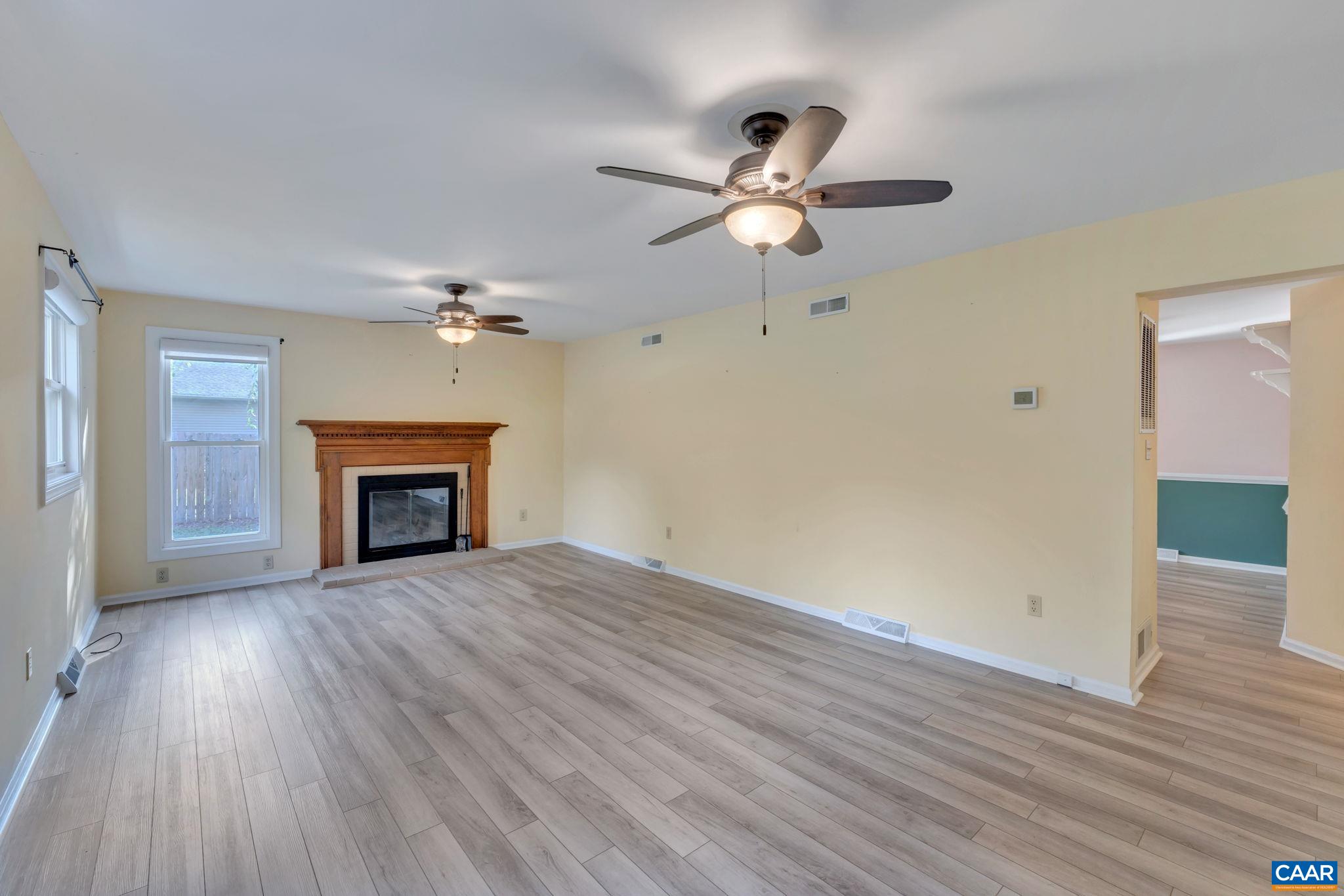 392 Minor Ridge Road Charlottesville, VA 22901 - Photo 28 of 47 an empty room with wooden floor fan and windows