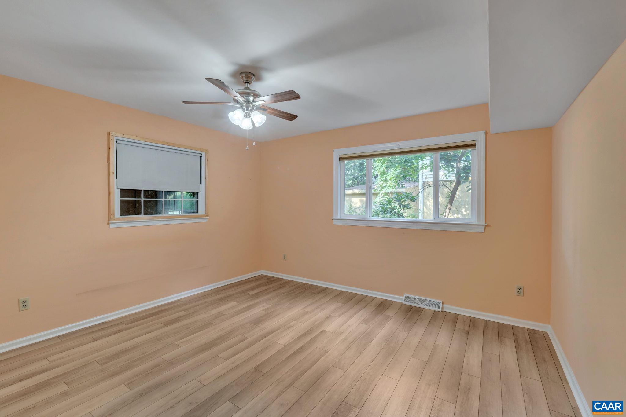 392 Minor Ridge Road Charlottesville, VA 22901 - Photo 32 of 47 a view of empty room with wooden floor and fan