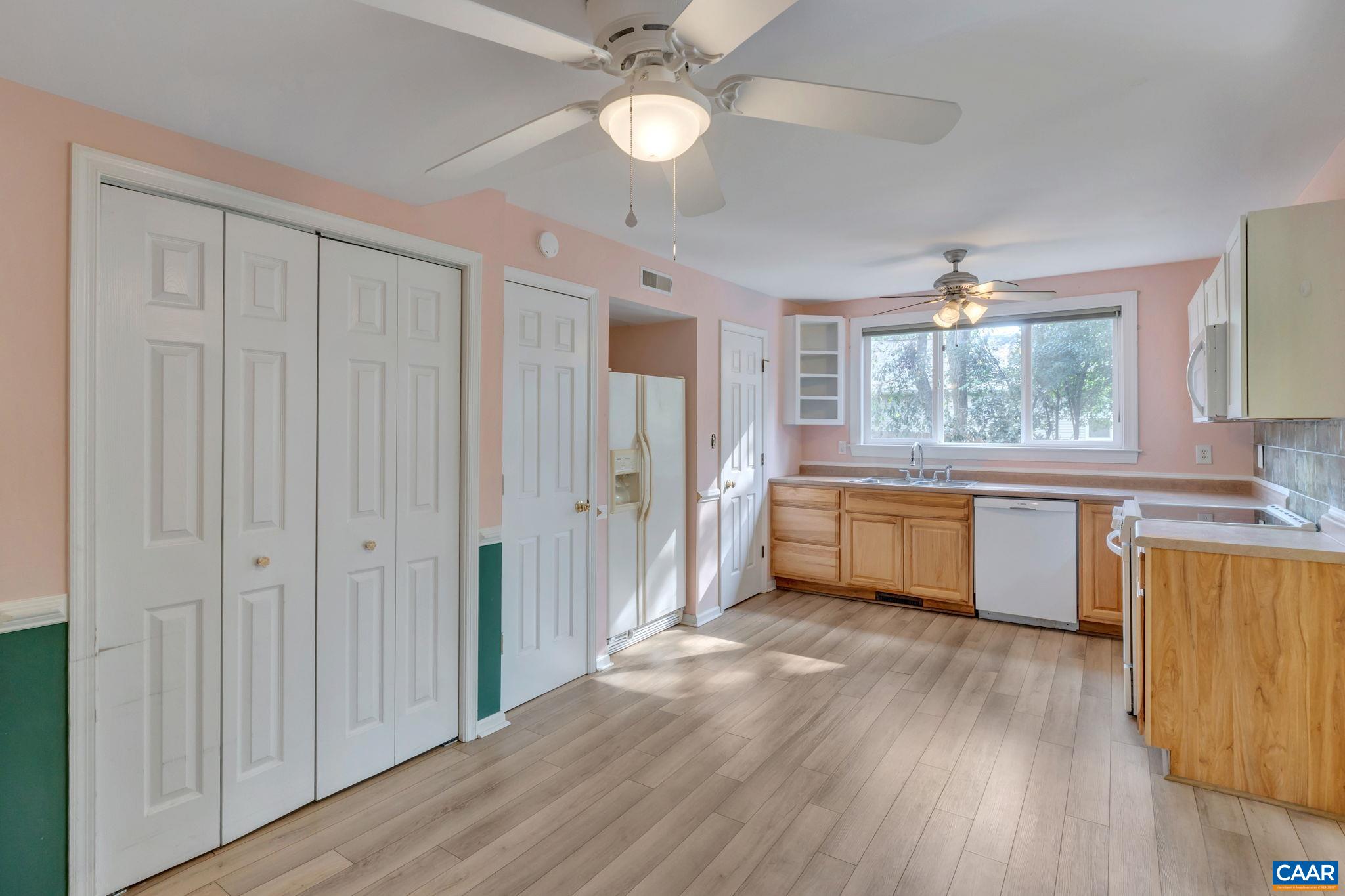 392 Minor Ridge Road Charlottesville, VA 22901 - Photo 38 of 47 a kitchen with stainless steel appliances granite countertop a refrigerator a sink dishwasher a stove with wooden floor and cabinets