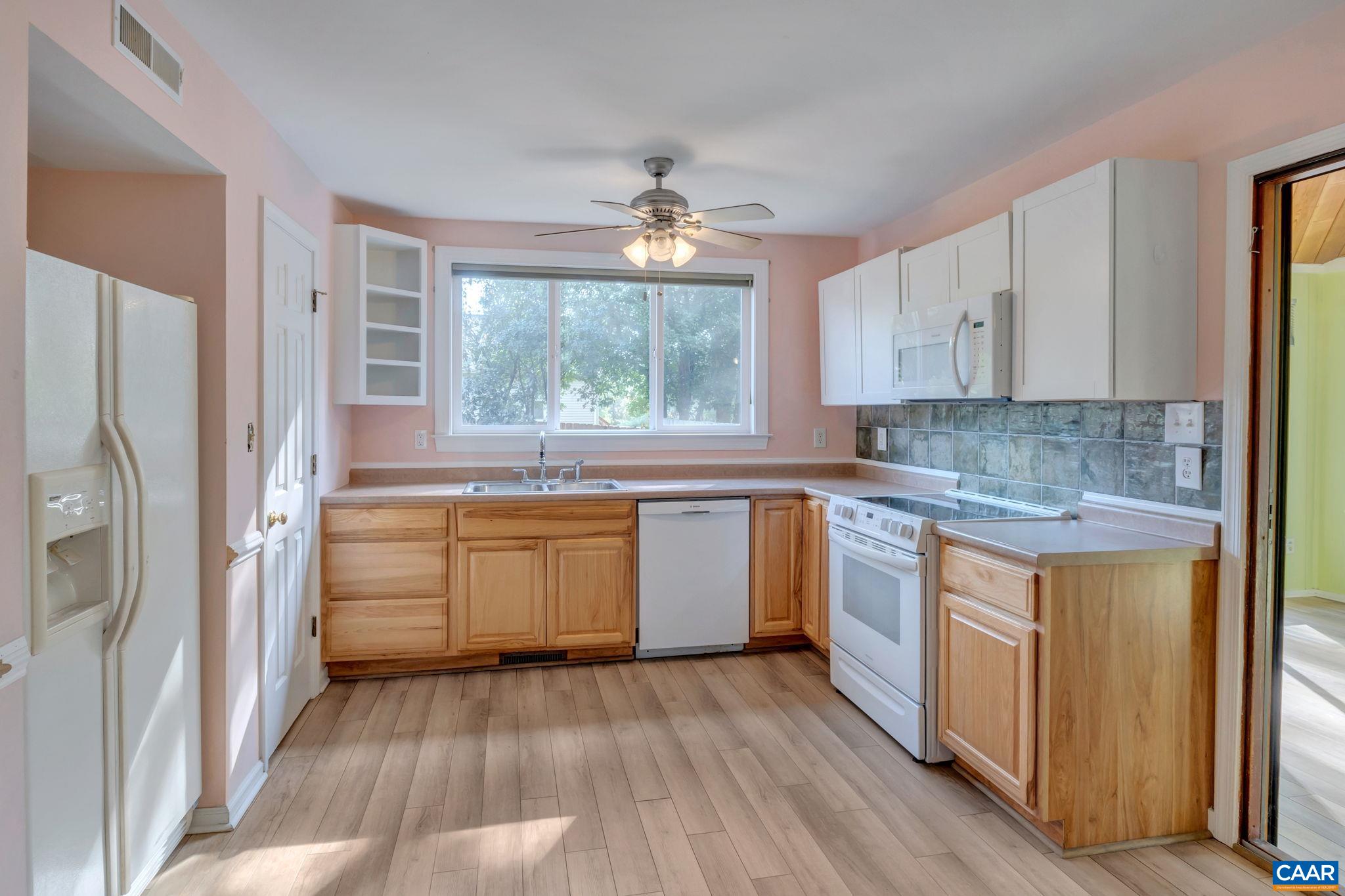 392 Minor Ridge Road Charlottesville, VA 22901 - Photo 39 of 47 a kitchen with a refrigerator wooden floor and window