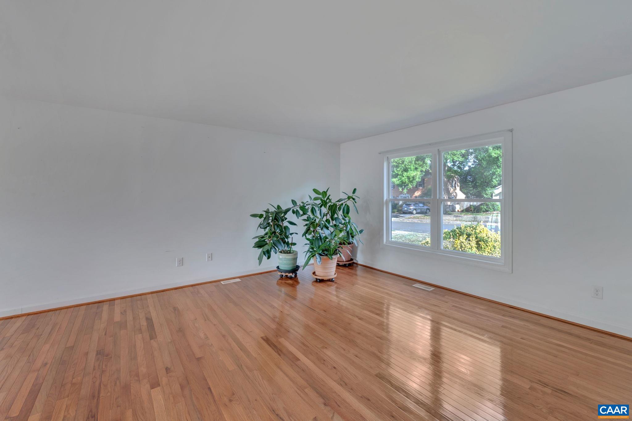 392 Minor Ridge Road Charlottesville, VA 22901 - Photo 8 of 47 a view of an empty room with a window and wooden floor