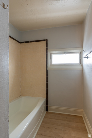 33 North 200 East Logan, UT 84321 - Photo 27 of 54 Bathroom with light wood finished floors and shower / washtub combination