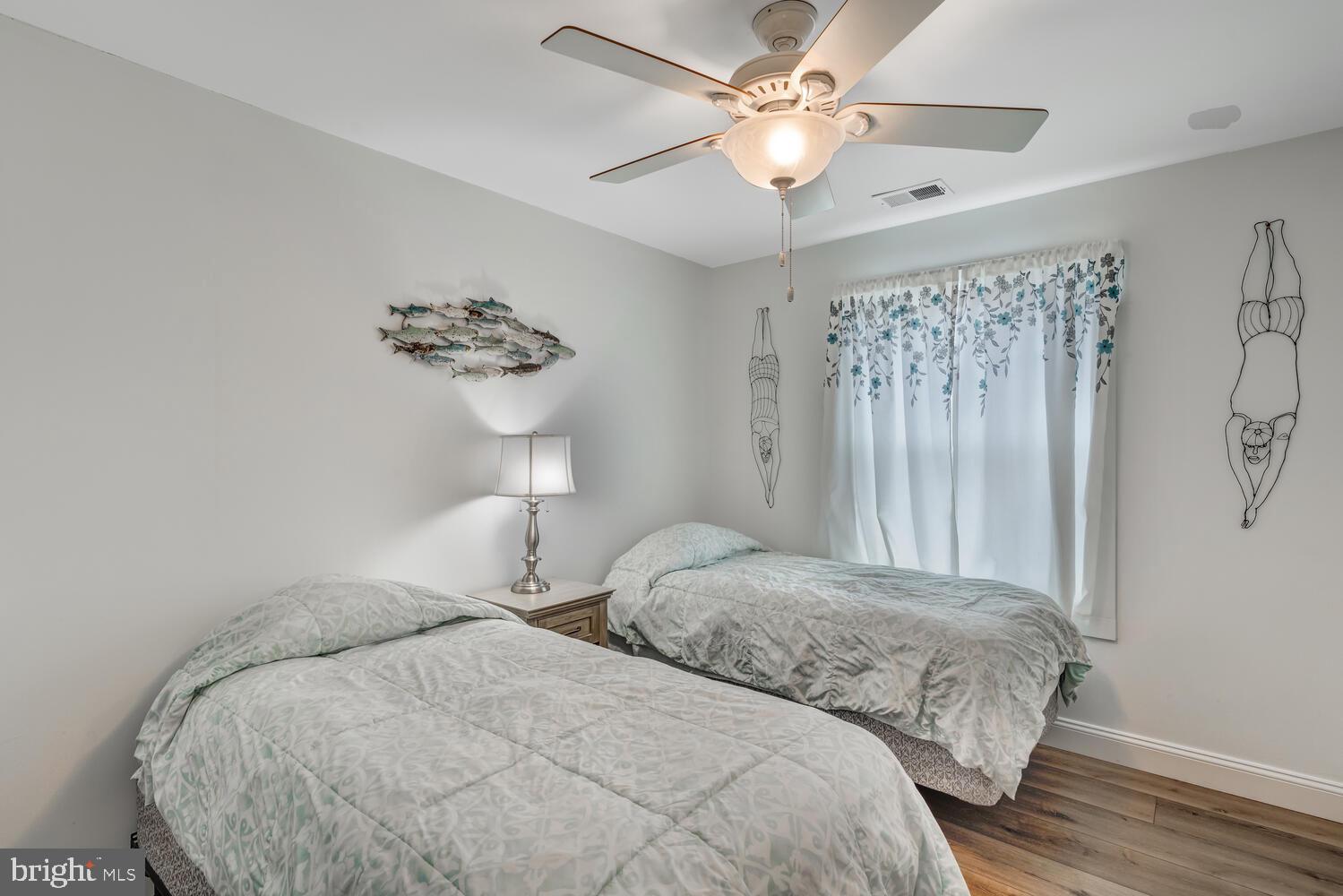 418 Dock Road West Creek, NJ 08092 - Photo 23 of 41 a bedroom with two beds and a chandelier