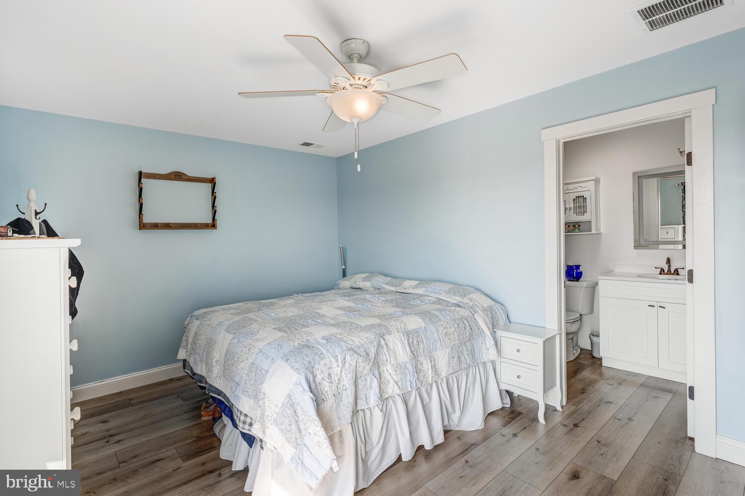 418 Dock Road West Creek, NJ 08092 - Photo 28 of 41 a bedroom with a large bed a chandelier and a window