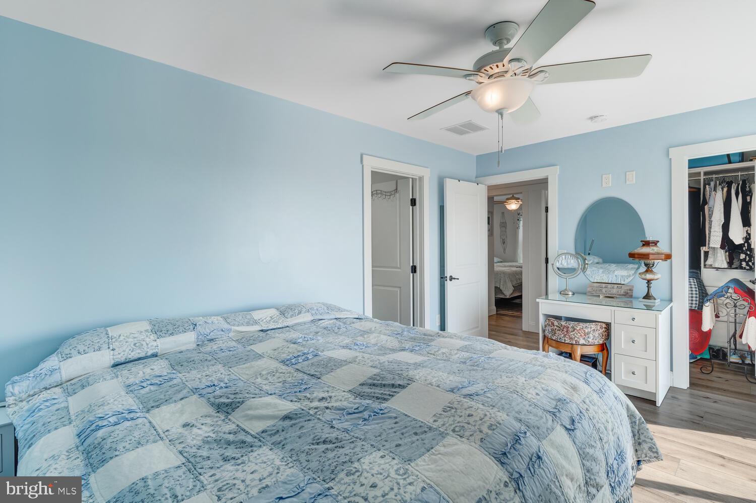 418 Dock Road West Creek, NJ 08092 - Photo 29 of 41 a bedroom with a large bed a chandelier and dresser