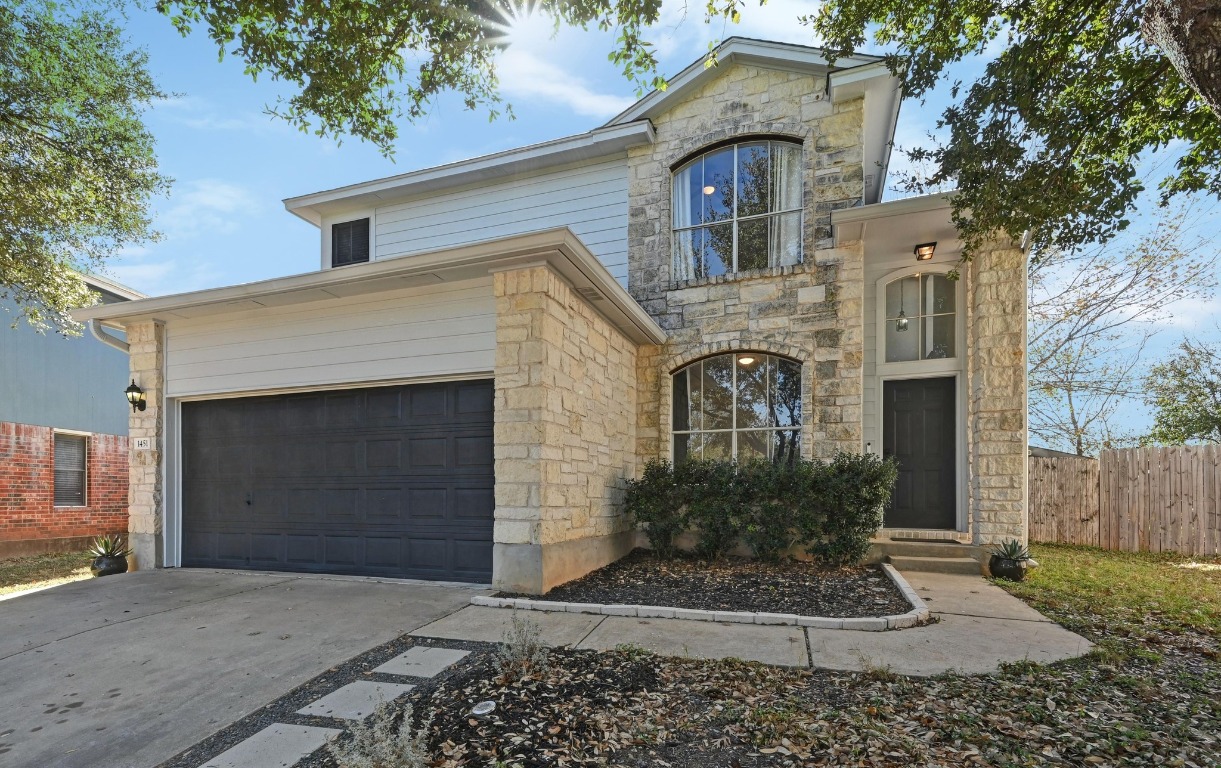 1451 Roxanne's Run Pflugerville, TX 78660 - Photo 1 of 17 front view of a house with a yard