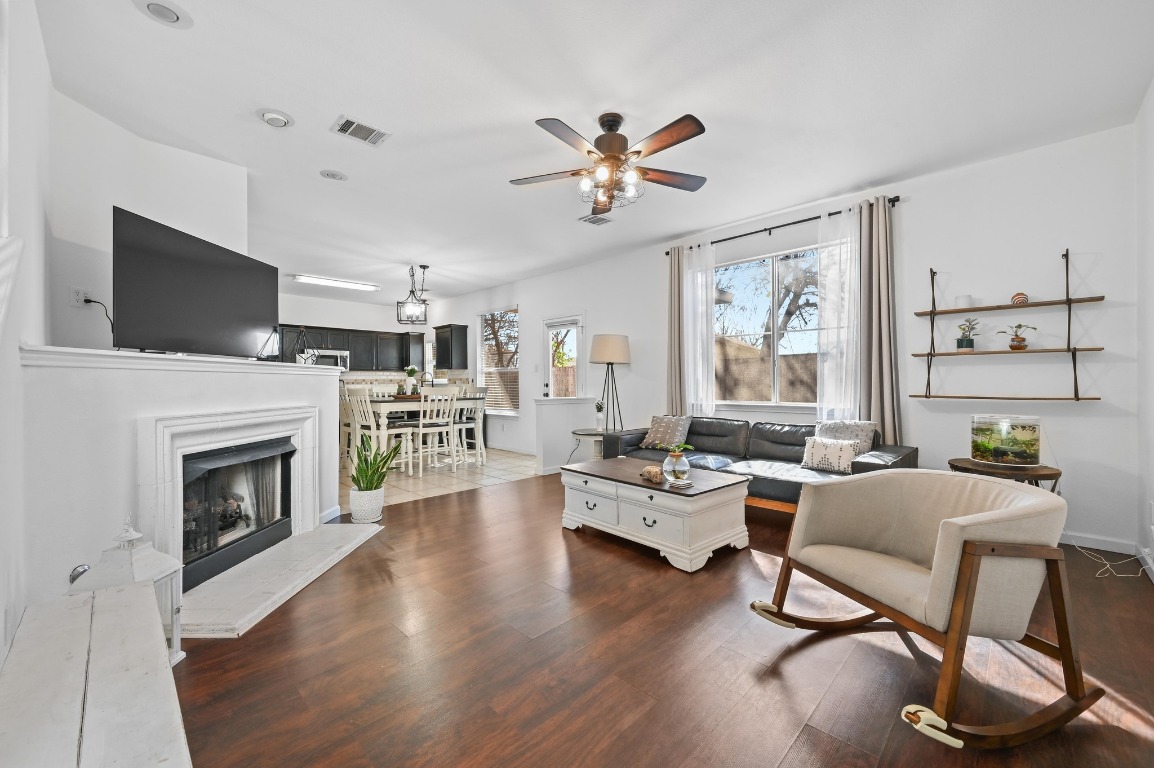 1451 Roxanne's Run Pflugerville, TX 78660 - Photo 4 of 17 a living room with furniture a fireplace and a flat screen tv