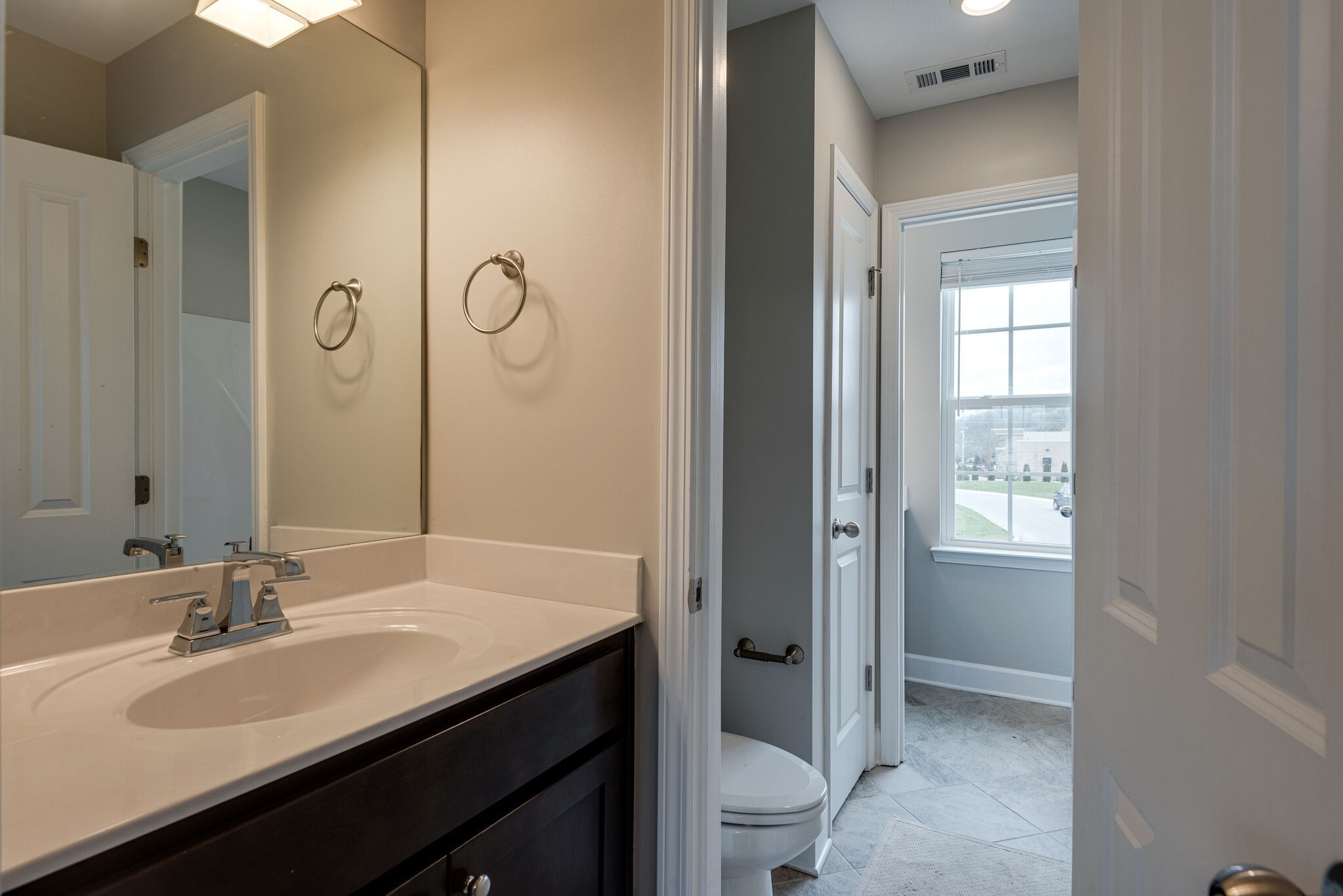 269 Mary Ann Circle Spring Hill, TN 37174 - Photo 24 of 28 a bathroom with a double vanity sink a toilet and shower